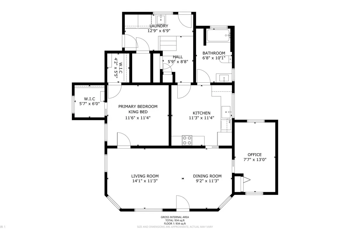 A wide view of the home’s interior that includes the primary bedroom, living room, kitchen, dining room, and office. The office space is visible, highlighting its role as a functional area that can serve as a second sleeping space.